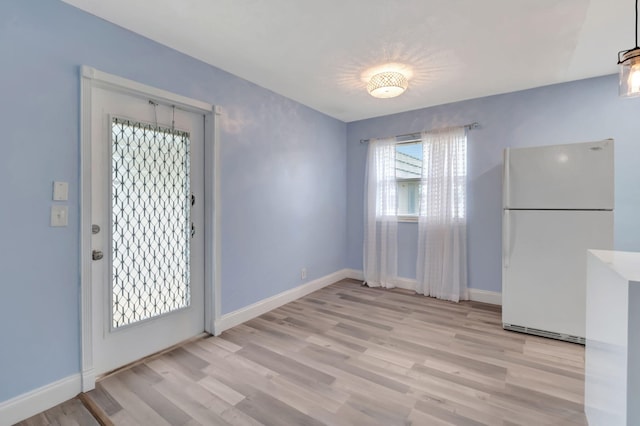 unfurnished dining area featuring light hardwood / wood-style floors