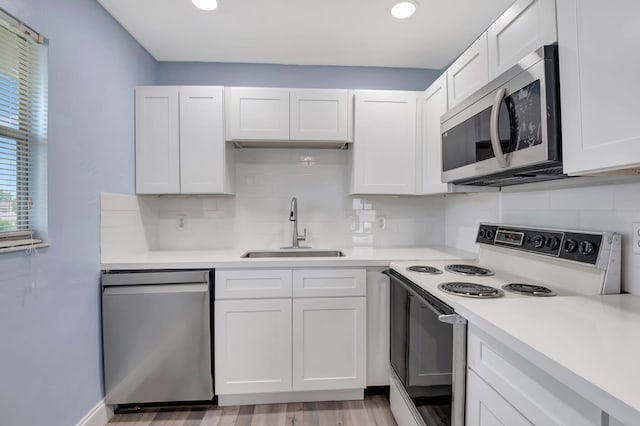 kitchen featuring white cabinets, appliances with stainless steel finishes, and sink