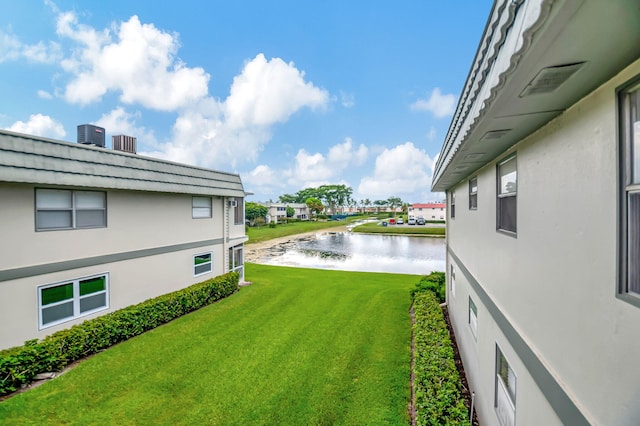 view of yard featuring a water view and central AC