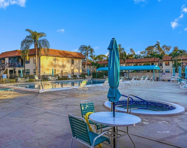 view of home's community featuring a patio and a swimming pool