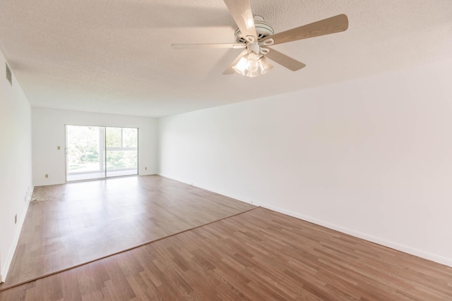 unfurnished room with a textured ceiling, ceiling fan, and hardwood / wood-style flooring