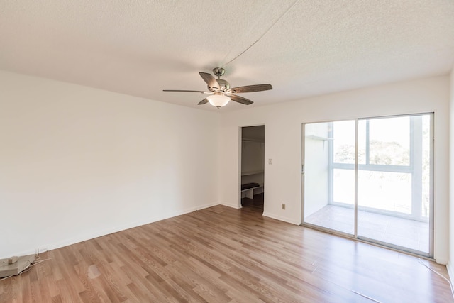 spare room featuring a textured ceiling, ceiling fan, and light hardwood / wood-style flooring