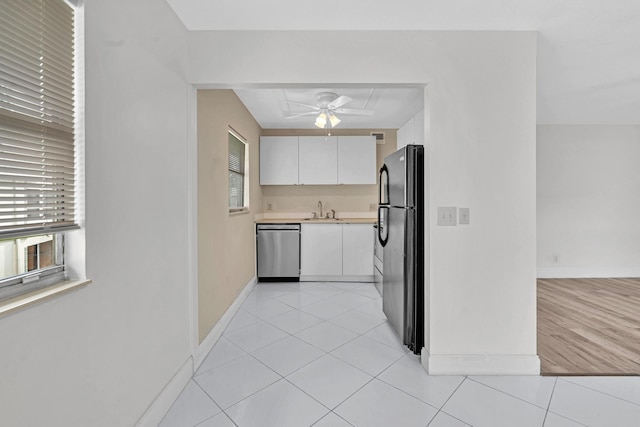 kitchen featuring light hardwood / wood-style floors, white cabinetry, dishwasher, ceiling fan, and black fridge