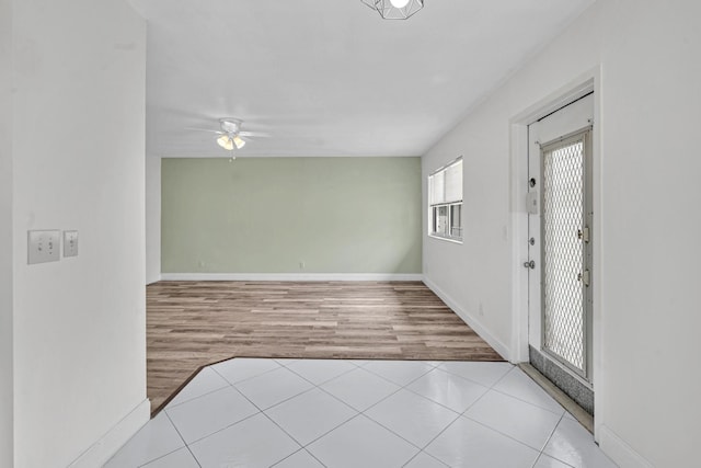 spare room featuring ceiling fan and light hardwood / wood-style floors