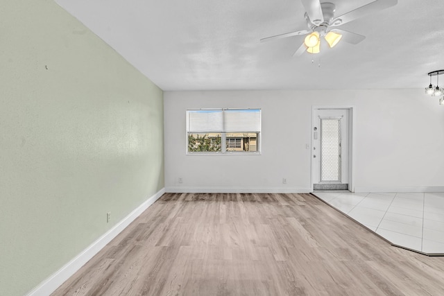 empty room with light hardwood / wood-style flooring and ceiling fan