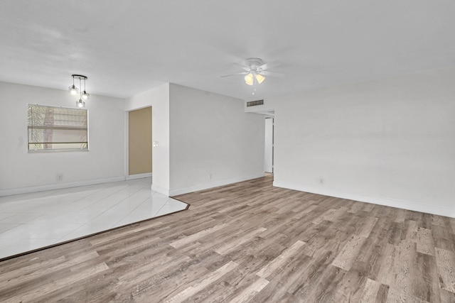 empty room with light wood-type flooring and ceiling fan