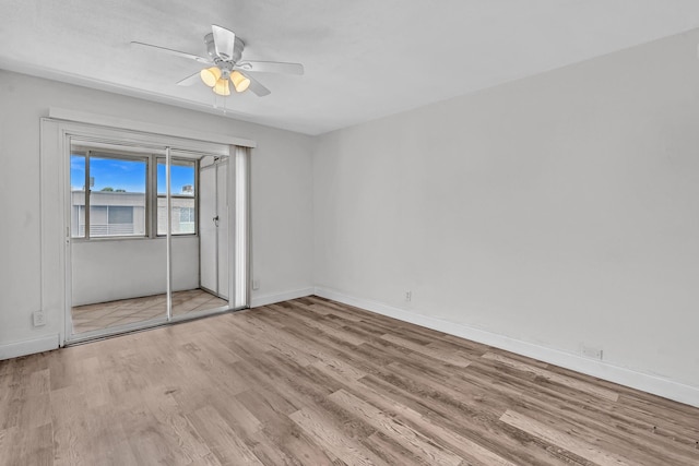 empty room with light hardwood / wood-style flooring and ceiling fan