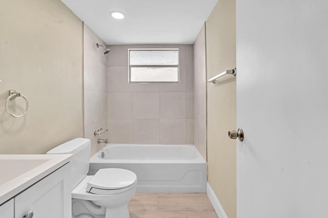 full bathroom featuring vanity, toilet, tiled shower / bath combo, and hardwood / wood-style flooring