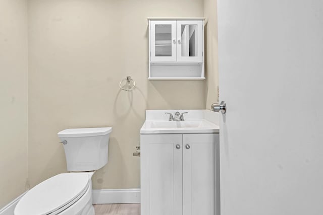 bathroom featuring vanity, toilet, and hardwood / wood-style flooring