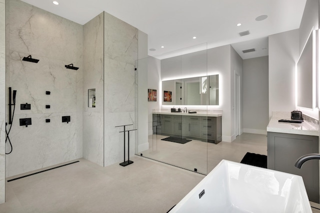 full bath featuring a marble finish shower, vanity, a freestanding bath, recessed lighting, and baseboards