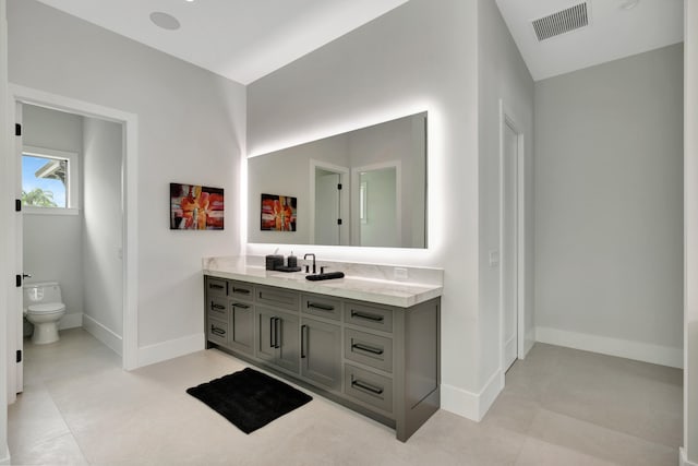 bathroom featuring vanity and toilet