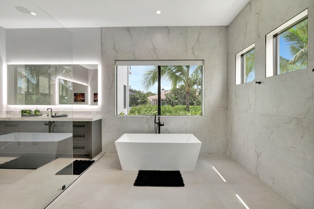 bathroom featuring vanity, concrete floors, and a washtub