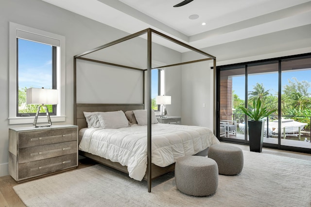 bedroom with ceiling fan, light wood-type flooring, multiple windows, and access to outside