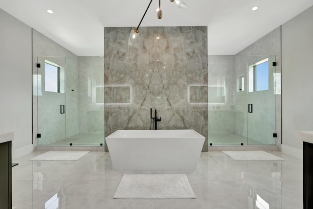 bathroom featuring vanity, tile walls, and separate shower and tub