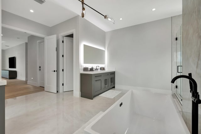 full bath with vanity, a tub, a stall shower, and recessed lighting