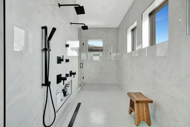 bathroom featuring a shower with shower door and tile walls