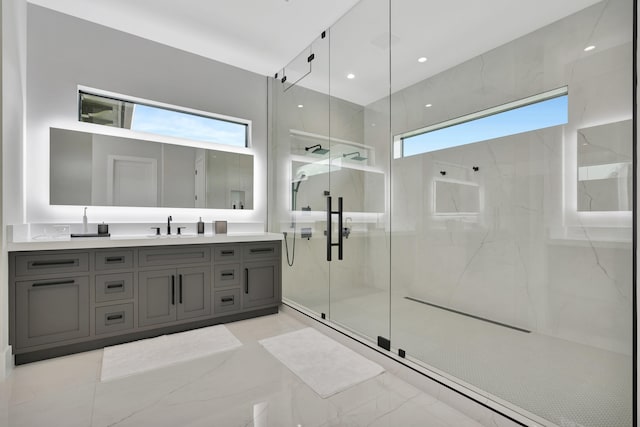 bathroom with a shower with door and vanity