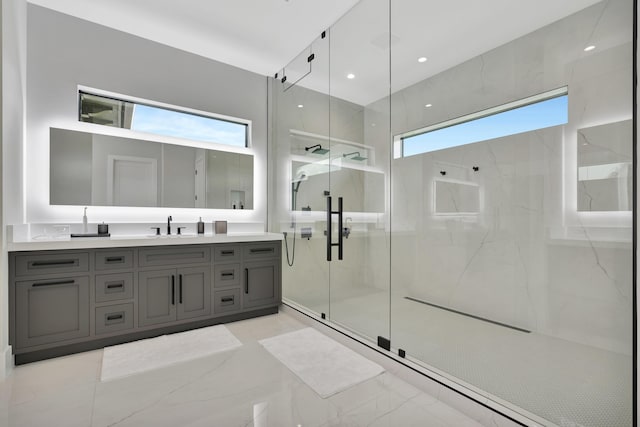 bathroom with a marble finish shower, vanity, and marble finish floors