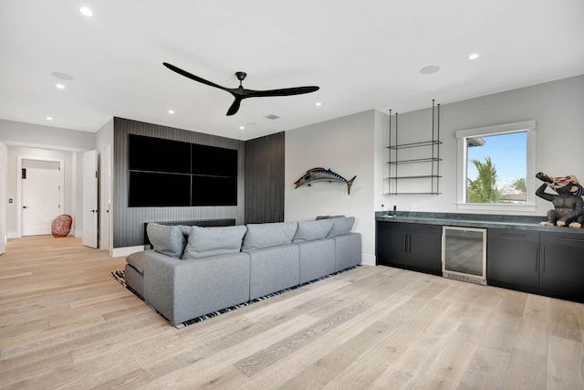 living area with wine cooler, ceiling fan, light wood-style floors, recessed lighting, and baseboards