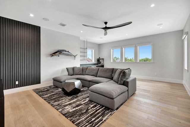 living room featuring ceiling fan and light hardwood / wood-style floors