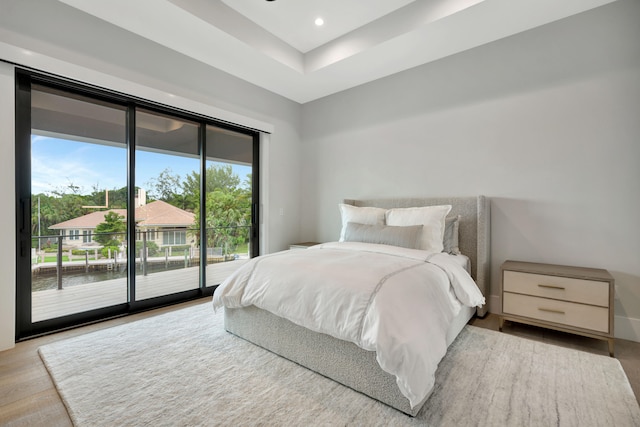 bedroom with light hardwood / wood-style floors and access to outside