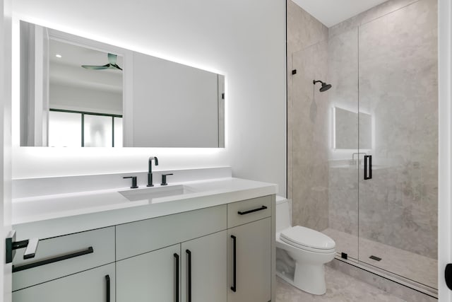 bathroom with tile patterned floors, toilet, a shower with door, and vanity