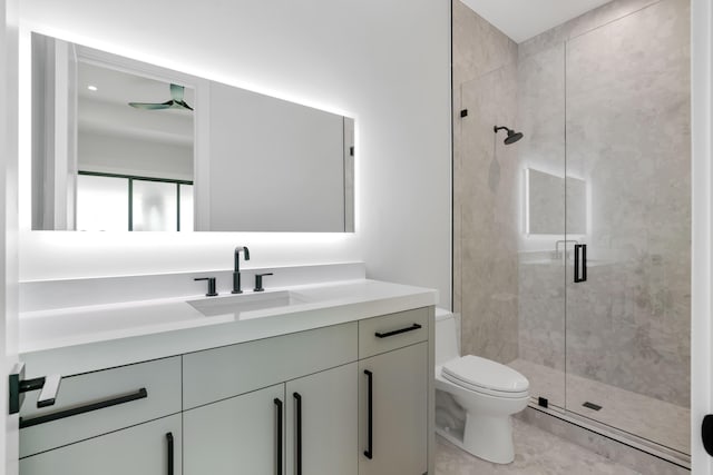 bathroom featuring a stall shower, toilet, and vanity