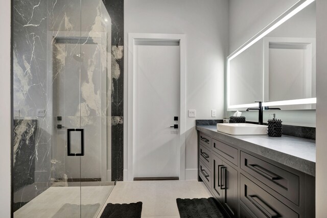 bathroom featuring vanity, walk in shower, and tile patterned flooring