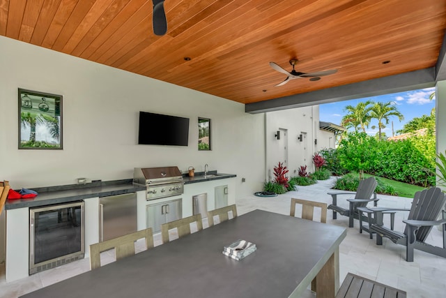 view of patio featuring sink, area for grilling, wine cooler, and ceiling fan