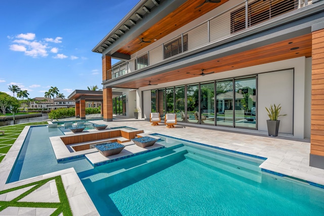 view of pool with an in ground hot tub, ceiling fan, and a patio area