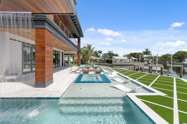 view of pool featuring a water view, a lawn, a patio, and an in ground hot tub