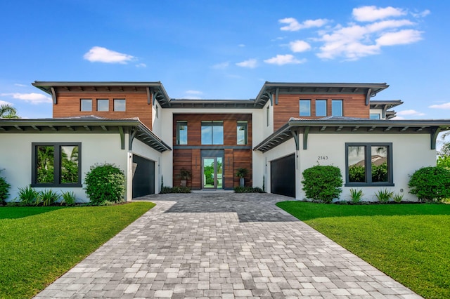 view of front of house with a garage and a front lawn