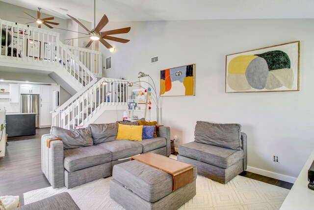 living room with high vaulted ceiling, ceiling fan, and wood-type flooring