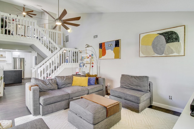 living area featuring stairs, light wood finished floors, and visible vents