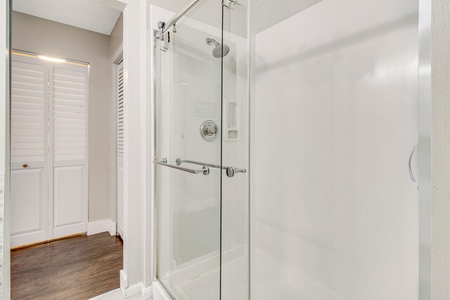 bathroom featuring an enclosed shower and hardwood / wood-style floors