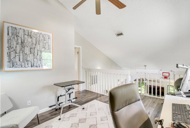 home office with a textured ceiling, high vaulted ceiling, ceiling fan, and hardwood / wood-style floors