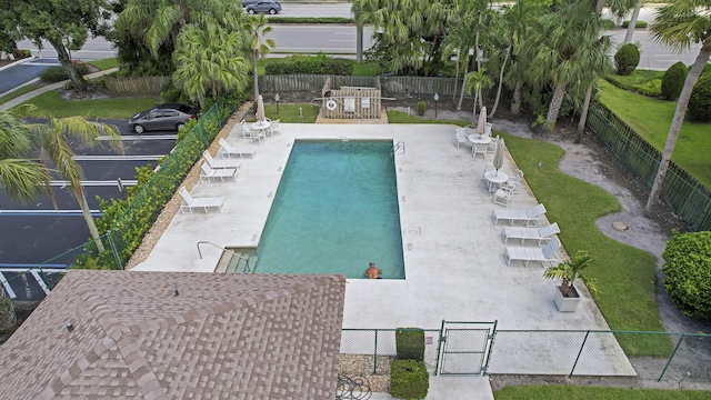 community pool featuring fence and a patio