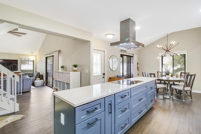 kitchen featuring a center island, lofted ceiling, light countertops, open floor plan, and island range hood