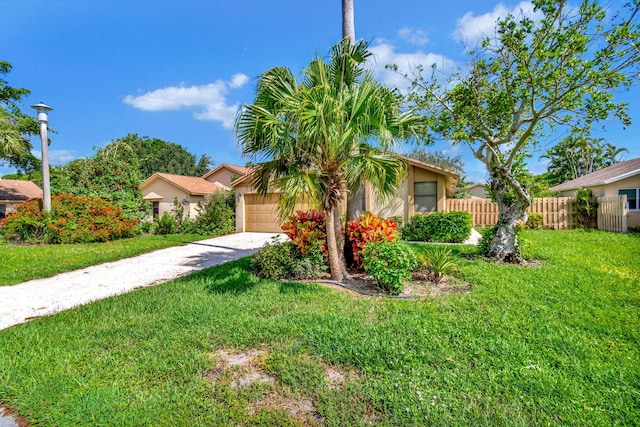 obstructed view of property with driveway, an attached garage, fence, a front lawn, and stucco siding