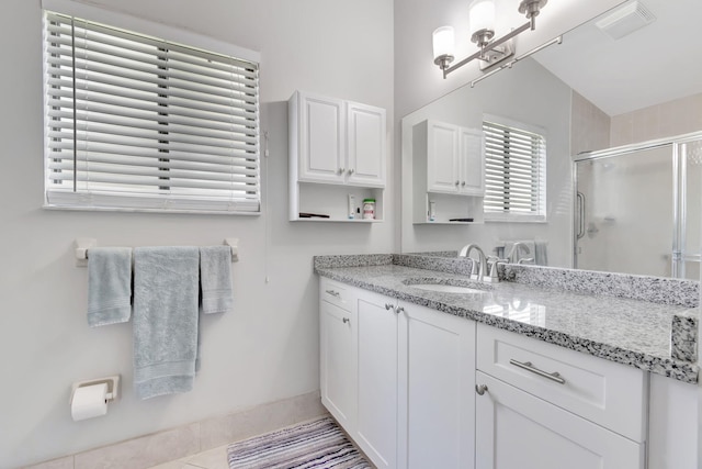 bathroom featuring plenty of natural light, vaulted ceiling, an enclosed shower, and vanity