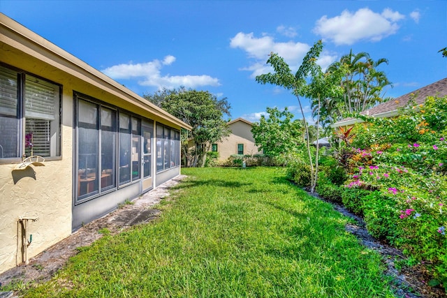 view of yard with a sunroom