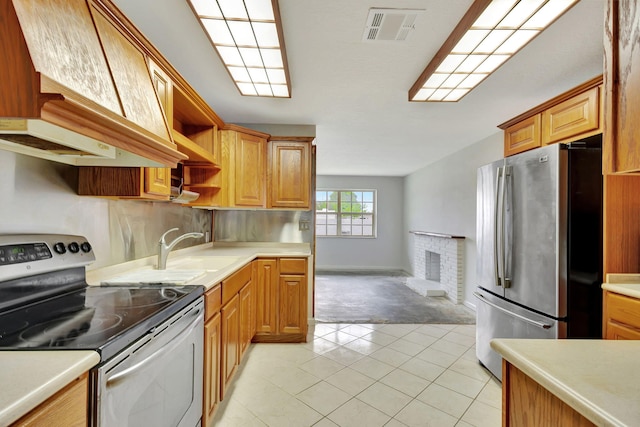 kitchen with light tile patterned flooring, sink, a fireplace, custom exhaust hood, and appliances with stainless steel finishes