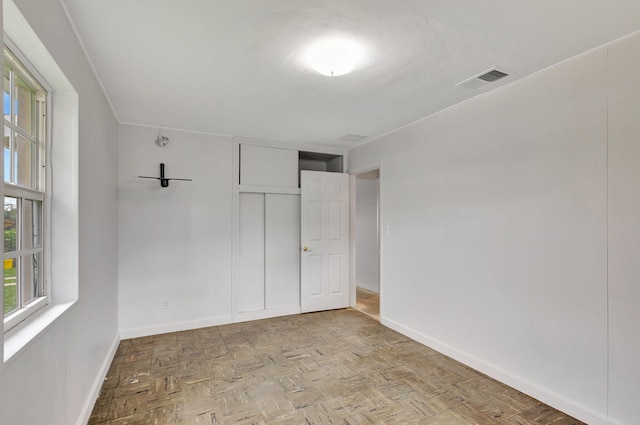 unfurnished bedroom featuring light parquet floors