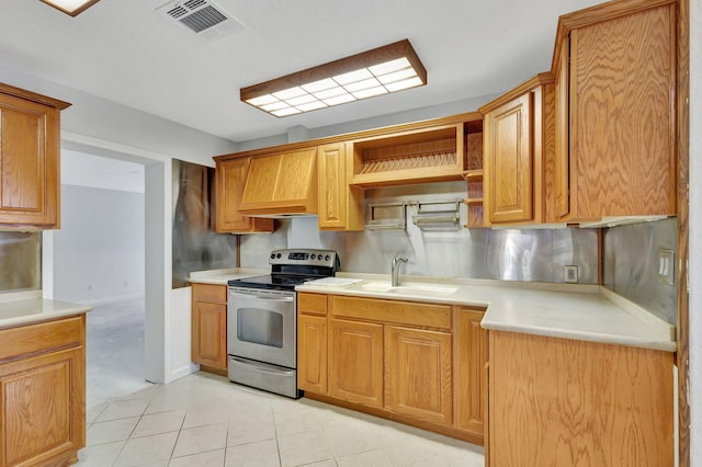 kitchen with tasteful backsplash, light tile patterned flooring, sink, custom exhaust hood, and stainless steel electric stove