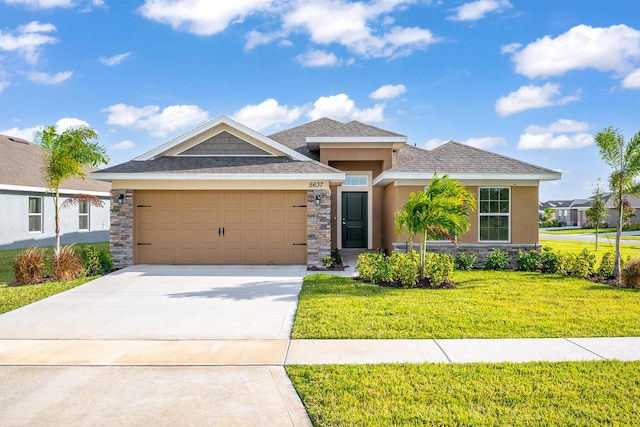 view of front of property with a garage and a front lawn