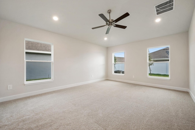 carpeted spare room featuring ceiling fan