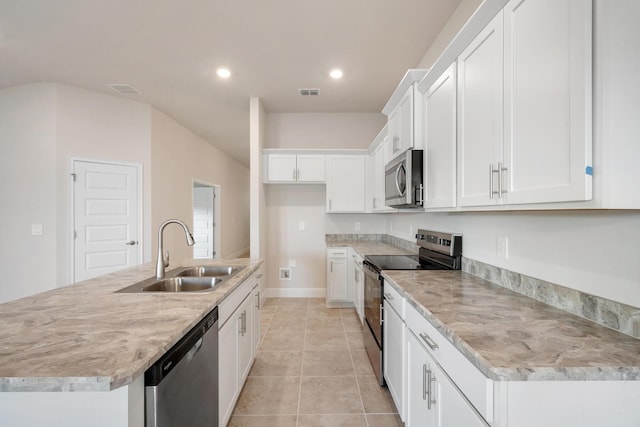 kitchen featuring white cabinets, sink, stainless steel appliances, and a kitchen island with sink