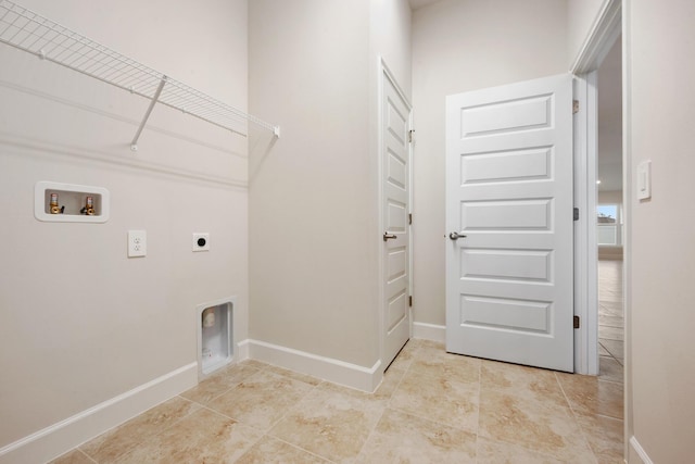 clothes washing area featuring hookup for a washing machine and hookup for an electric dryer