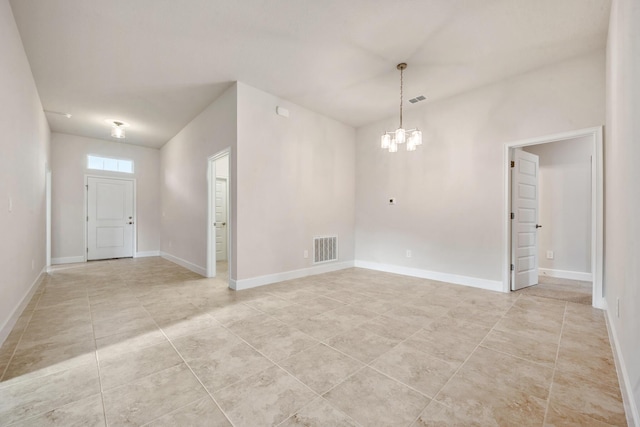 unfurnished room featuring a notable chandelier and light tile patterned floors