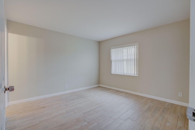 spare room featuring light hardwood / wood-style floors